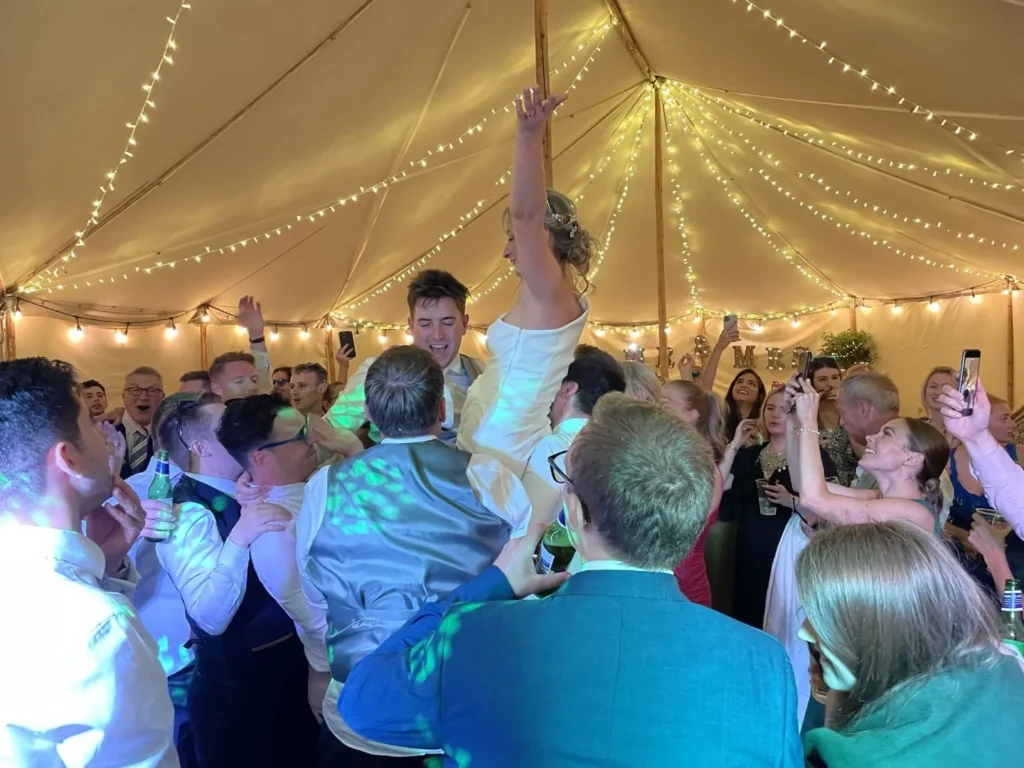 Wedding crowd lifting bride in celebration - Colchester DJ entertainment