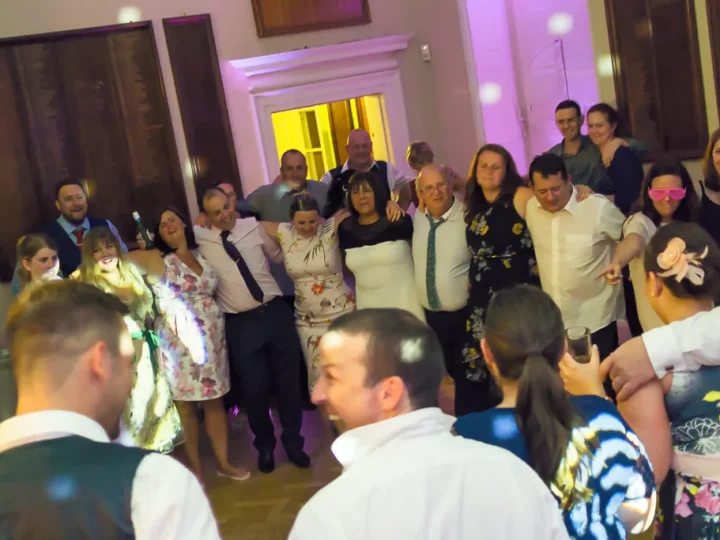 Wedding reception party with purple uplighting and elegant venue setting - Essex